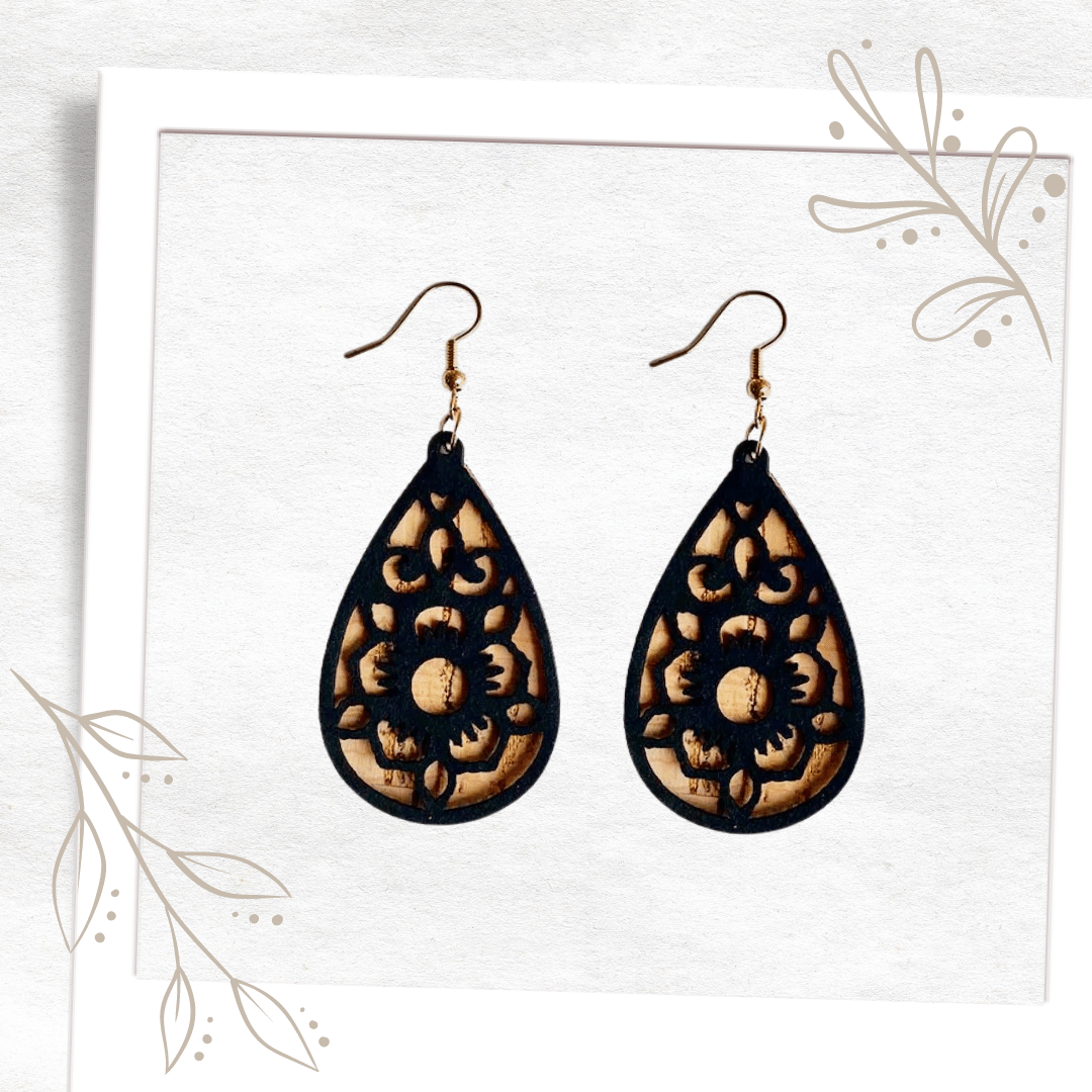 These distinctive eco-fashion cork earrings are sure to wow! Featuring two cork laser-cut teardrops, the solid base colour is a natural cork colour, highlighted by an intricate, delicate flower design in black. Super lightweight, you will forget you are wearing them until the compliments flood in! Statement eco, sustainable cork earrings that are going to grab attention. 